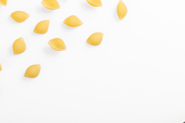 Pasta products in the form of a shell texture on a white background closeup