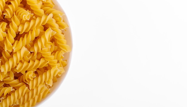 Pasta products in the form of a spiral on a plate texture on a white background