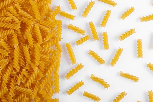 Pasta products in the form of a spiral texture on a white background closeup