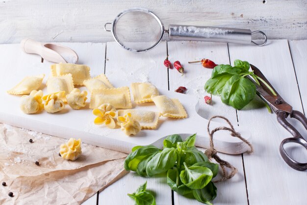 Pasta ravioli on flour with basil