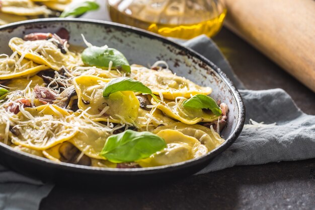 Pasta ravioli stuffed with spinach mustooms prosciutto basil and parmesan cheese.