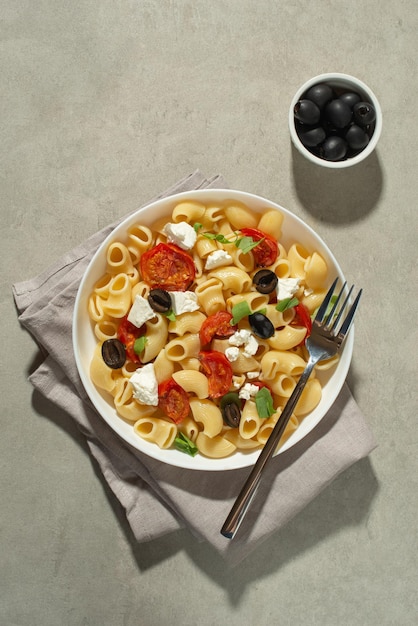 Pasta salad with dried tomatoes cheese and olives