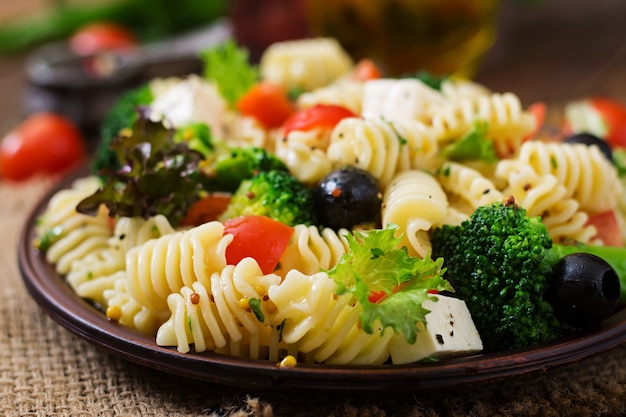 Pasta salad with tomato, broccoli, black olives, and cheese feta