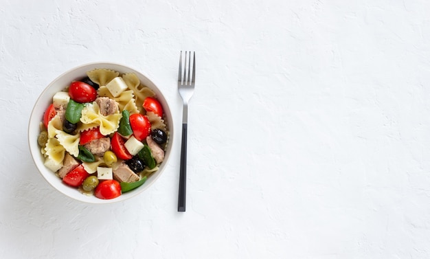 Pasta salad with tuna, tomatoes and white cheese. Farfalle. Healthy eating. Diet.