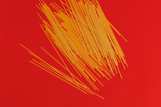 Pasta scattered on a red background