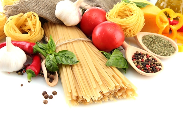 Pasta spaghetti vegetables and spices isolated on white