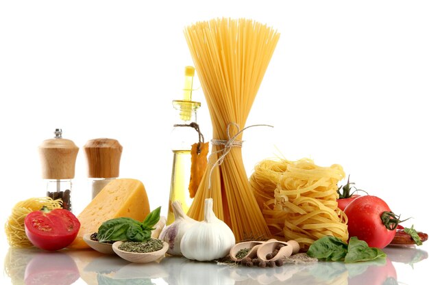 Pasta spaghetti vegetables spices and oil isolated on white