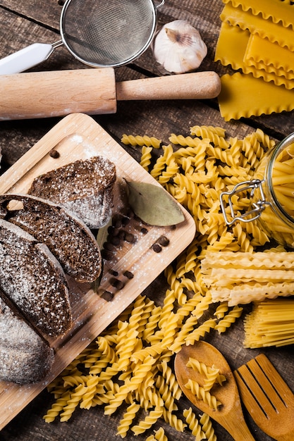 Pasta spaghetti with flour, egg on old wooden background