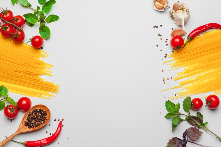 Photo pasta spaghetti with ingredients for cooking pasta on a white background, top view.