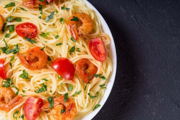 Pasta Spaghetti with shrimps tomatoes and parslley Seafood background