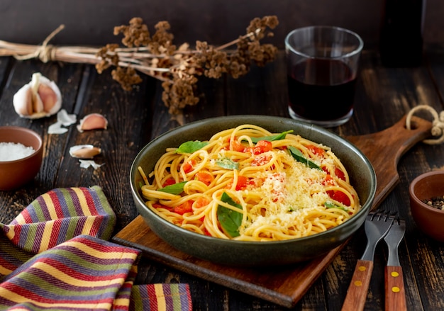 Pasta spaghetti with tomatoes, basil and parmesan cheese. Italian cuisine. Recipe. Healthy eating.