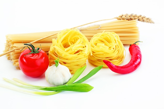 Pasta on a white background in a composition with accessories for the kitchen