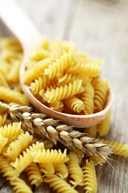 Pasta on a white background in a composition with accessories for the kitchen