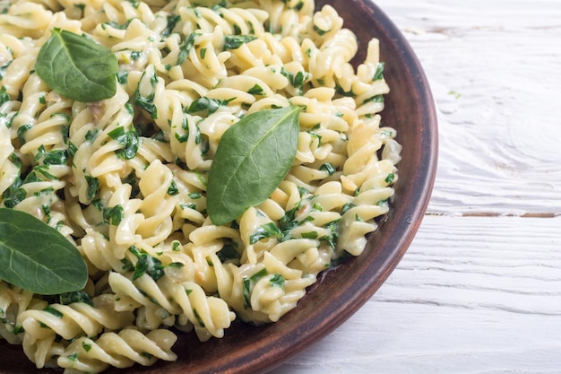 Pasta with baby spinach Italian food background