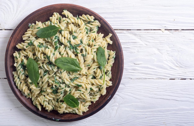 Pasta with baby spinach Italian food background