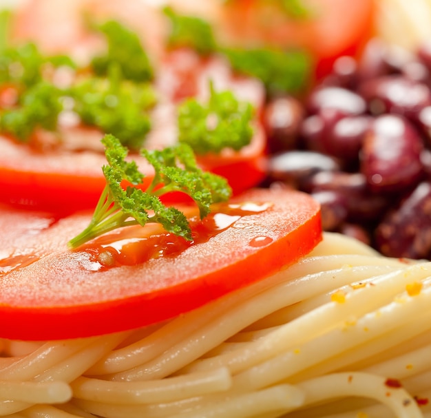 Pasta with baked beans and fresh tomatoes.