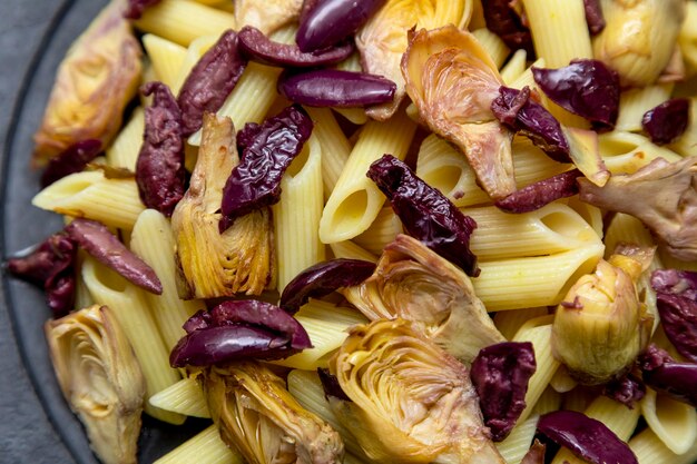 Pasta with black olives and artichoke hearts,