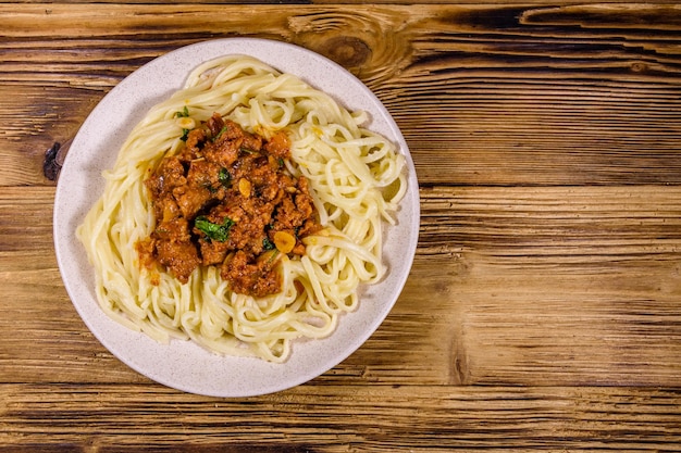 Pasta with bolognese sauce in a ceramic plate Top view