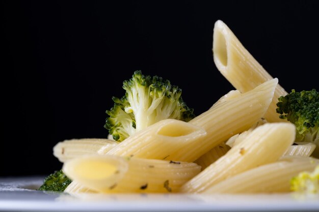 Pasta with broccoli on a black background