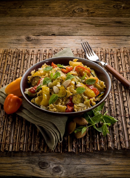 Pasta with capsicum zucchinis and sliced almond