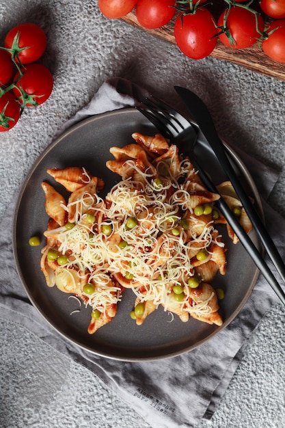 Pasta with cherry tomatoes, peas and Parmesan cheese. Homemade Italian pasta with tomatoes and sauce