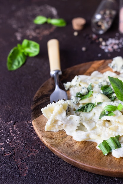 Pasta with creamy sauce with basil and gorgonzola cheese