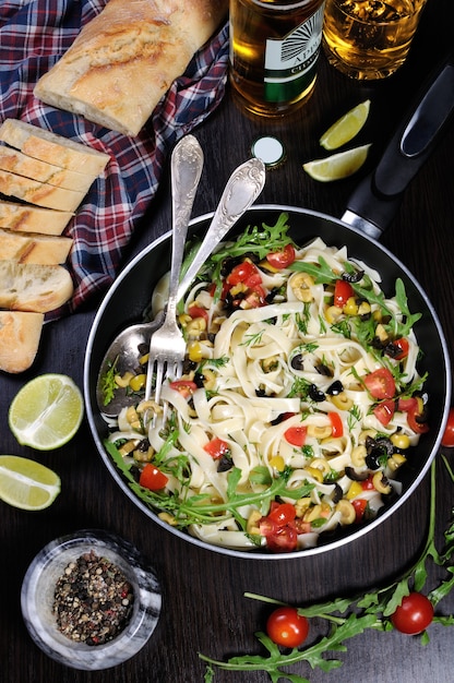 Pasta with crushed olives and cherry tomatoes, arugula.