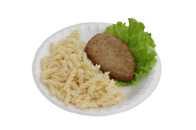 Photo pasta with cutlet and lettuce leaf on a white plate on a white background