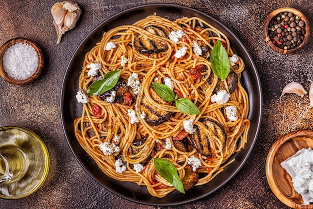 Pasta with eggplant, tomato, cheese, and basil