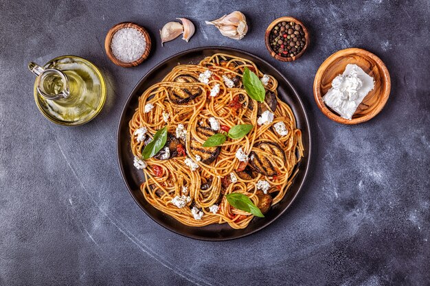 Pasta with eggplant, tomato, cheese, and basil