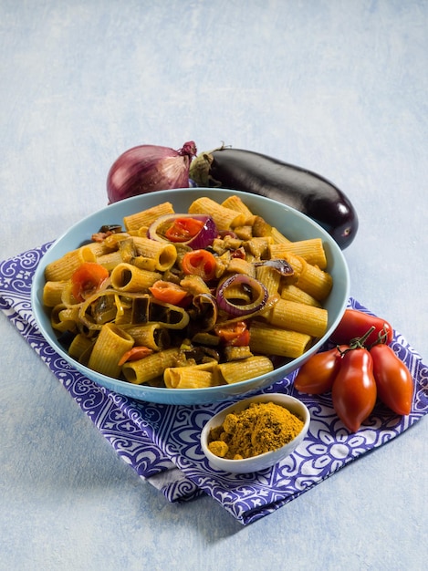 Pasta with eggplants tomatoes and curry