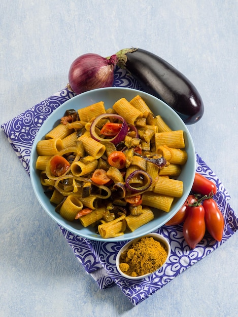 Pasta with eggplants tomatoes and curry
