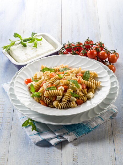 Pasta with feta cheese fresh tomatoes and mint leaf