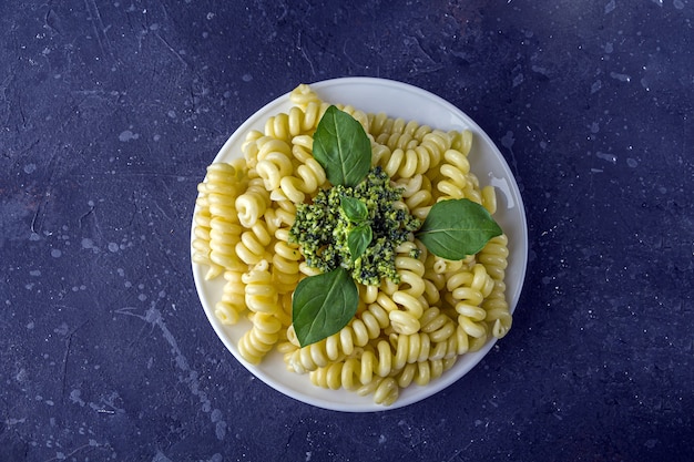 Pasta with fresh pesto sauce on a white plate