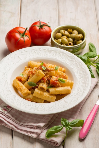 Pasta with fresh tomatoes green olives and basil