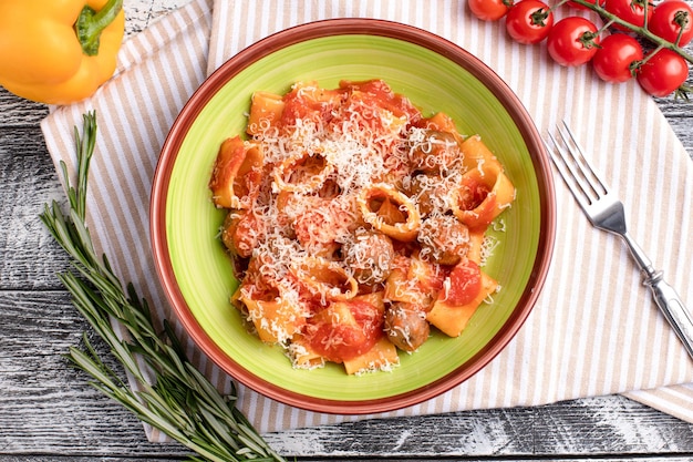 Pasta with meat balls pasta with tomatoes and meat on a white wooden background top view