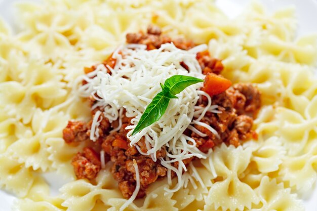 Pasta with meat cheese and garnish with mint.