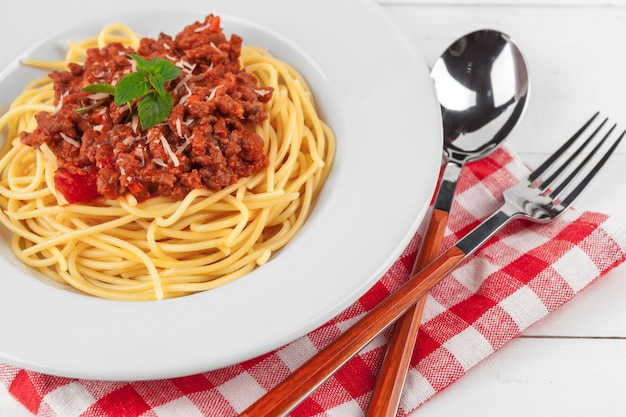 Pasta with meat, tomato sauce and vegetables on the table