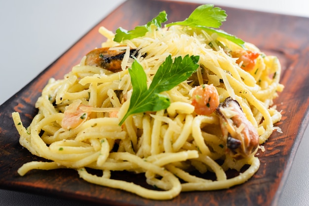 Pasta with mussels and prawns in creamy sauce. 