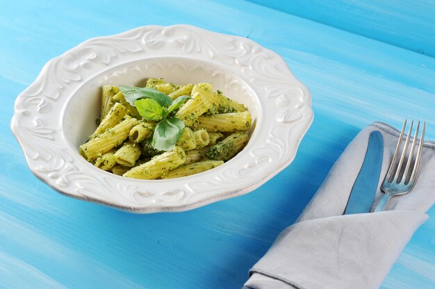 Pasta with pesto sauce and Basil in plate