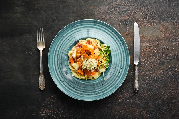 Pasta with pineapple and carrots In the plate Top view Free space for your text Rustic style