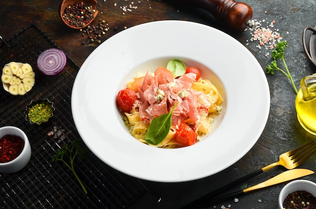 Pasta with prosciutto blue cheese and tomatoes italian cuisine\
menu top view