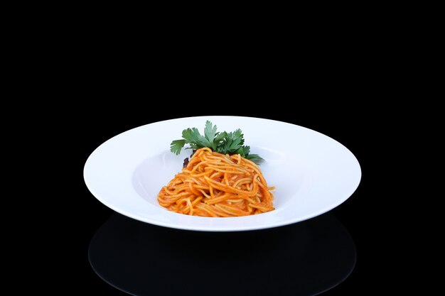 Pasta with red sauce and parsley in white plate