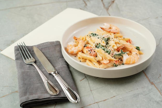 Pasta with shrimps and herbs Seafood dish in cafe