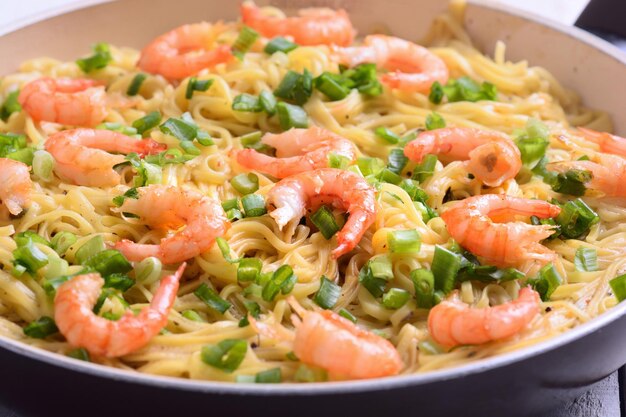 Pasta with shrimps on wooden background