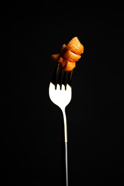 Pasta with tomato sauce on dark background. High quality photo