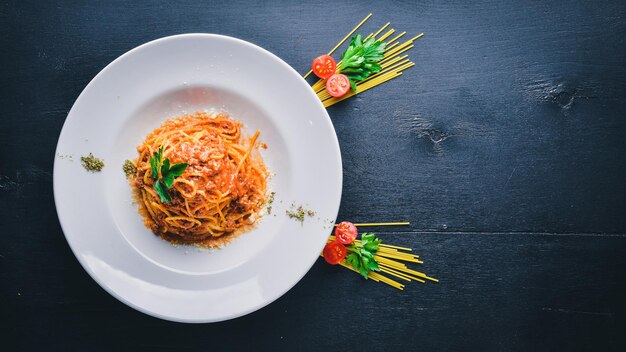 Pasta with tomato sauce and parmesan cheese Italian traditional food On a wooden background Top view Free space for your text