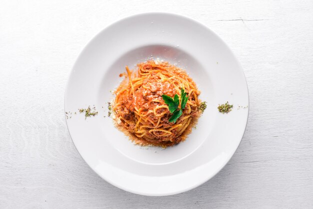 Pasta with tomato sauce and parmesan cheese Italian traditional food On a wooden background Top view Free space for your text