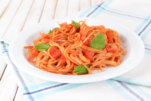 Pasta with tomato sauce on plate on table closeup