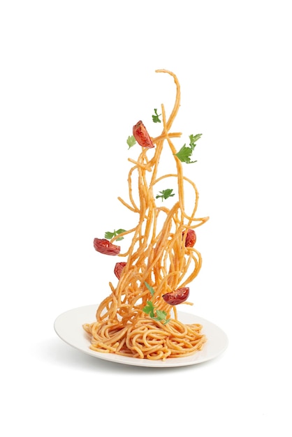 Pasta with tomatoes and basil falling into a plate levitation